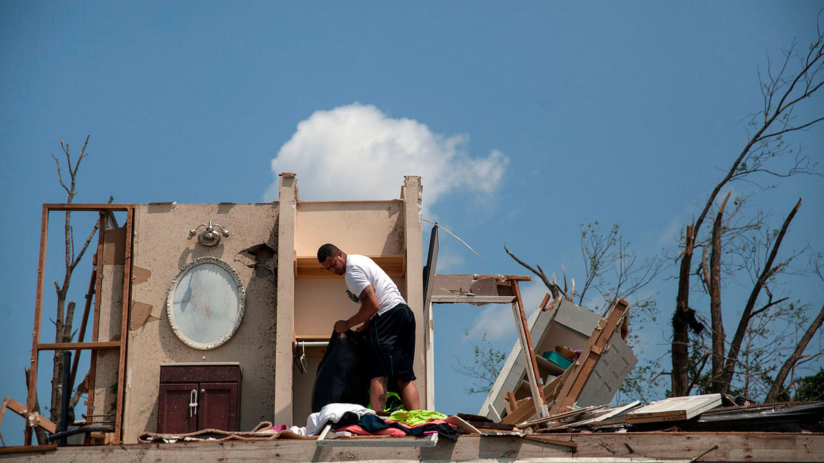 A man gathers his belongings from his damaged home in Trotwood, Ohio, on 28 May 2019, after powerful tornadoes ripped through the US state overnight, causing at least one fatality and widespread damage and power outages. Photo: AFP