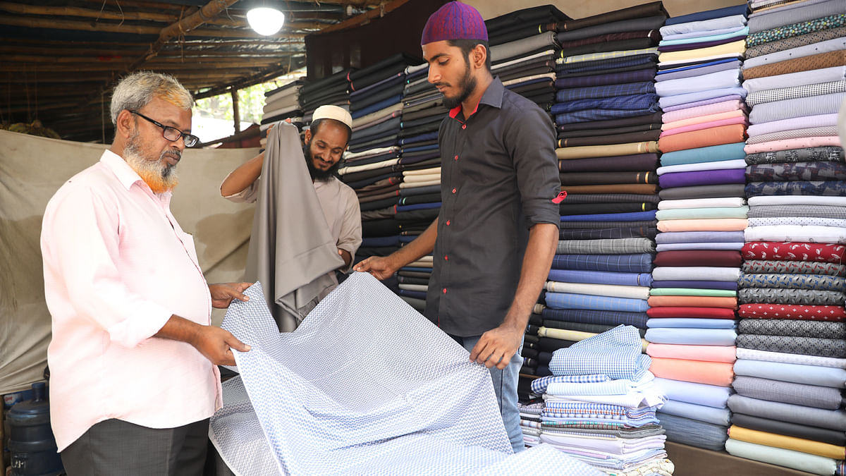 Customer look at clothes at a market during the month of Ramadan and ahead of Eid al-Fitr celebrations in Motijheel, Dhaka on 29 May 2019 Photo: Abdus Salam