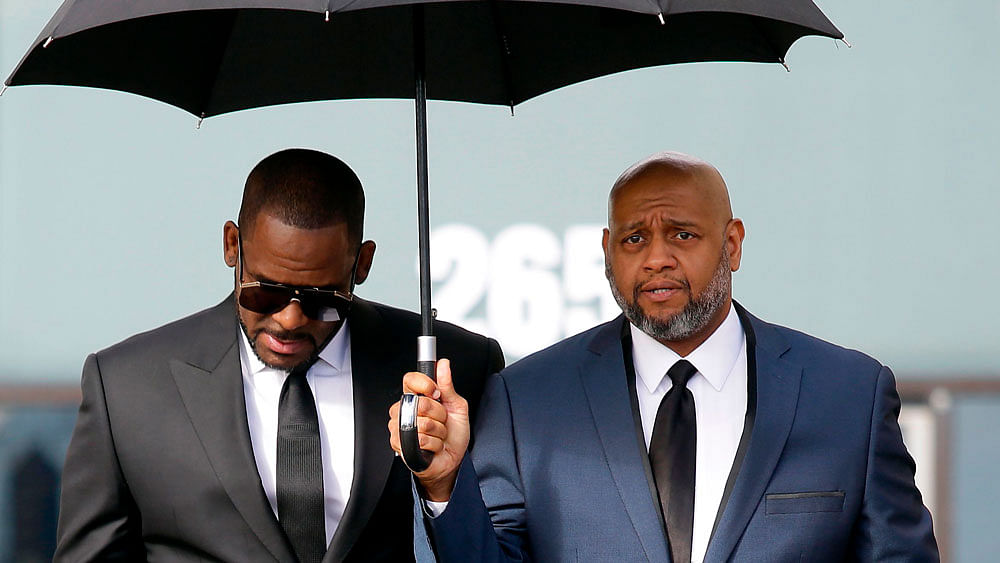 In this file photo taken on 22 March US music artist R Kelly (L) leaves the George N Leighton Criminal Court Building after a hearing for his sex abuse case in Chicago, Illinois. Photo: AFP