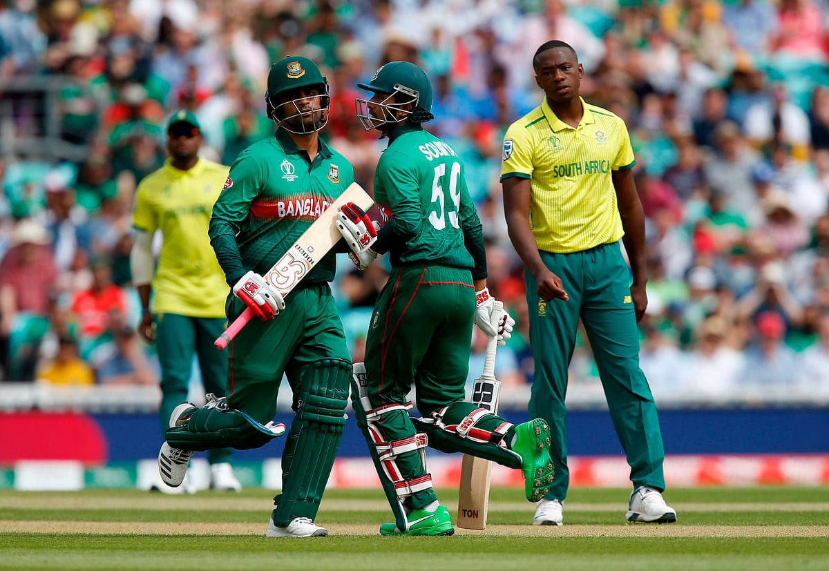 Bangladesh`s Tamim Iqbal (L) and Soumya Sarkar (C) run between the wickets as South Africa`s Kagiso Rabada (R) looks on during the 2019 Cricket World Cup group stage match between South Africa and Bangladesh at The Oval in London on 2 June 2019.Photo: AFP
