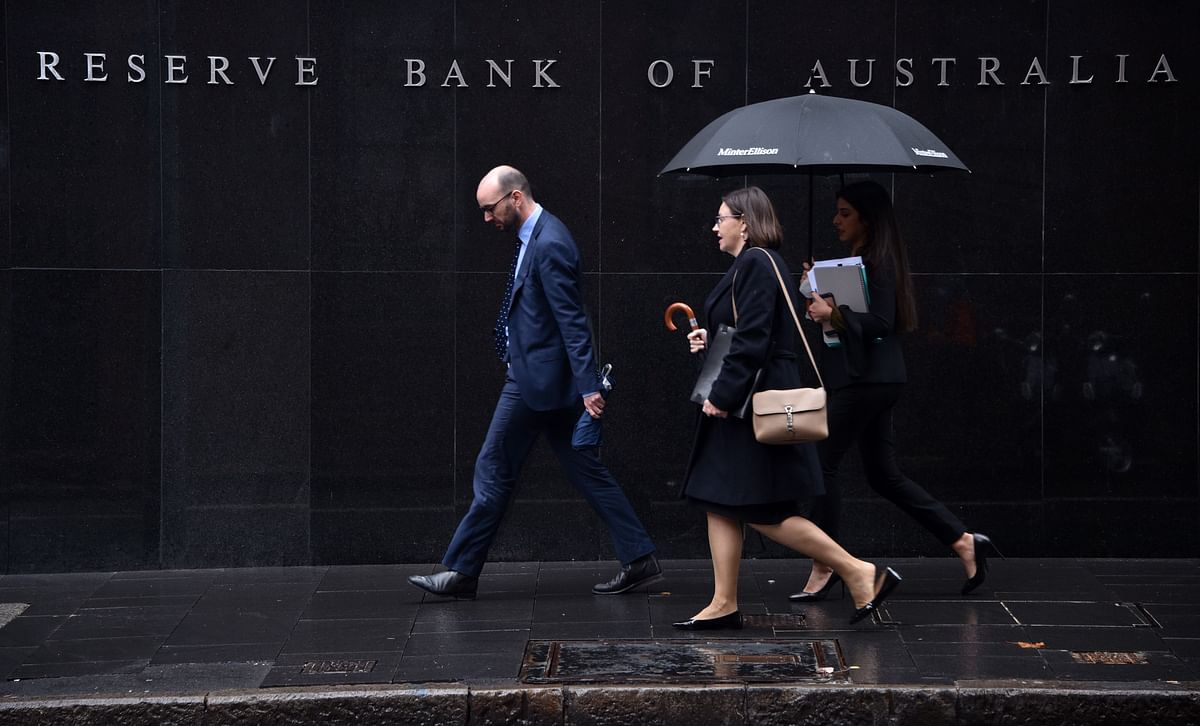 Pedestrians walks past the Reserve Bank of Australia in Sydney on 4 June. Photo: AFP