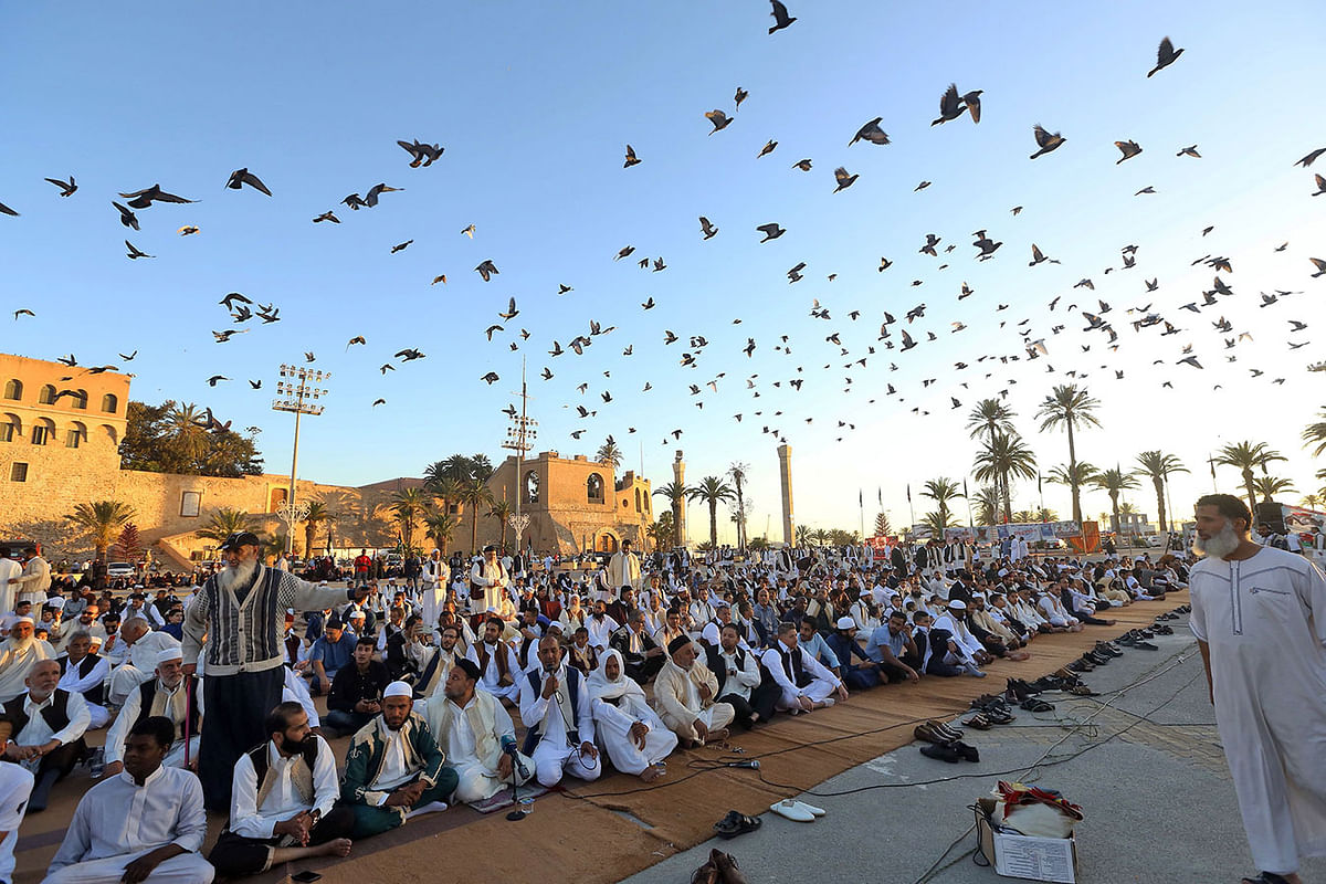 Libyan Muslim worshippers gather to perform Eid al-Fitr prayers at the Martyrs Square of the capital Tripoli on 4 June, 2019. Muslims worldwide celebrate Eid al-Fitr marking the end of the Muslim holy month of Ramadan. Photo: AFP