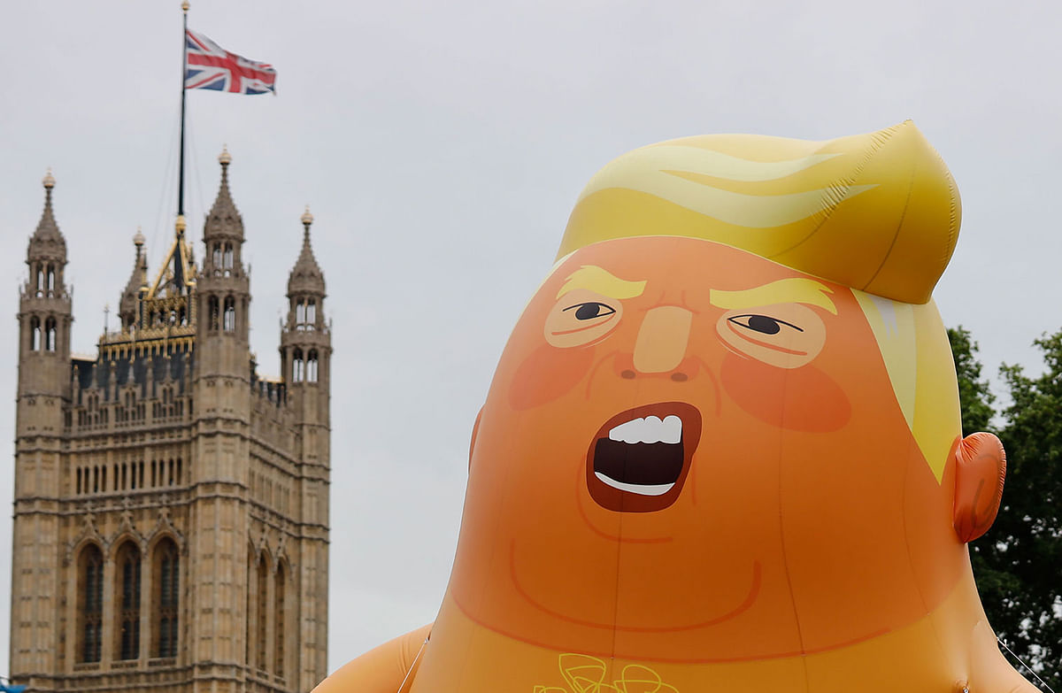 A giant balloon depicting US President Donald Trump as an orange baby floats above anti-Trump demonstrators in Parliament Square outside the Houses of Parliament in London on 4 June, 2019, on the second day of Trump`s three-day State Visit to the UK. Photo: AFP