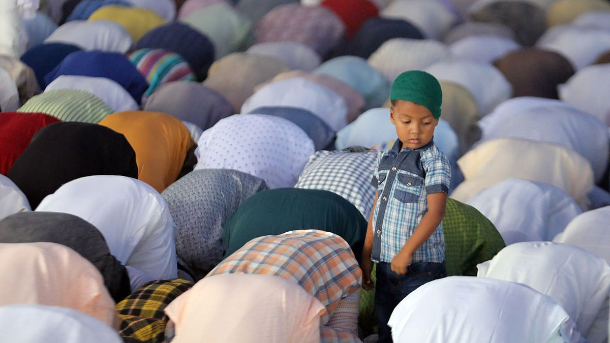 The child joins Eid jamaat at Jamiatul Falah Mosque premises in Chattogram on Wednesday. Photo: Sourav Das