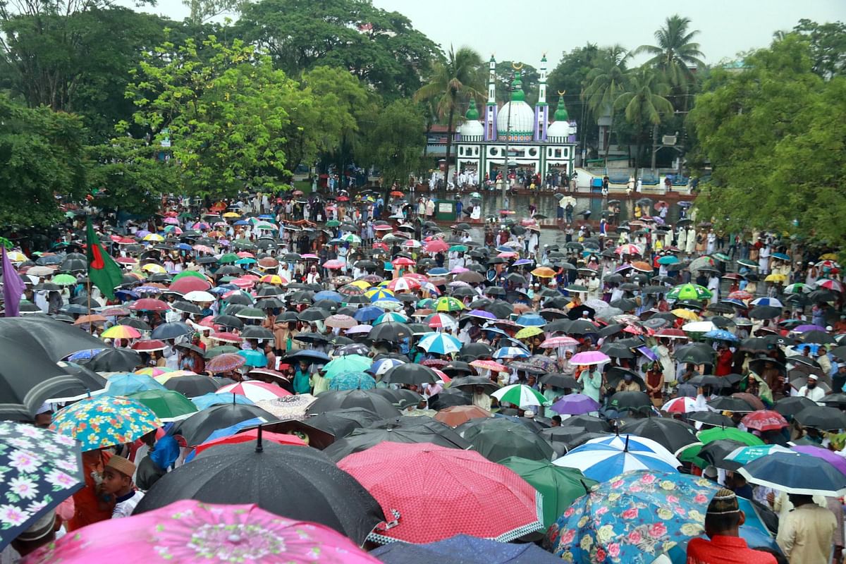 The main jamaat of Eid-ul-Fitr has been held at the Central Shahi Eidgah premises in Sylhet on Wednesday. Devotees with umbrellas join the prayers. Photo: Anis Mahmud