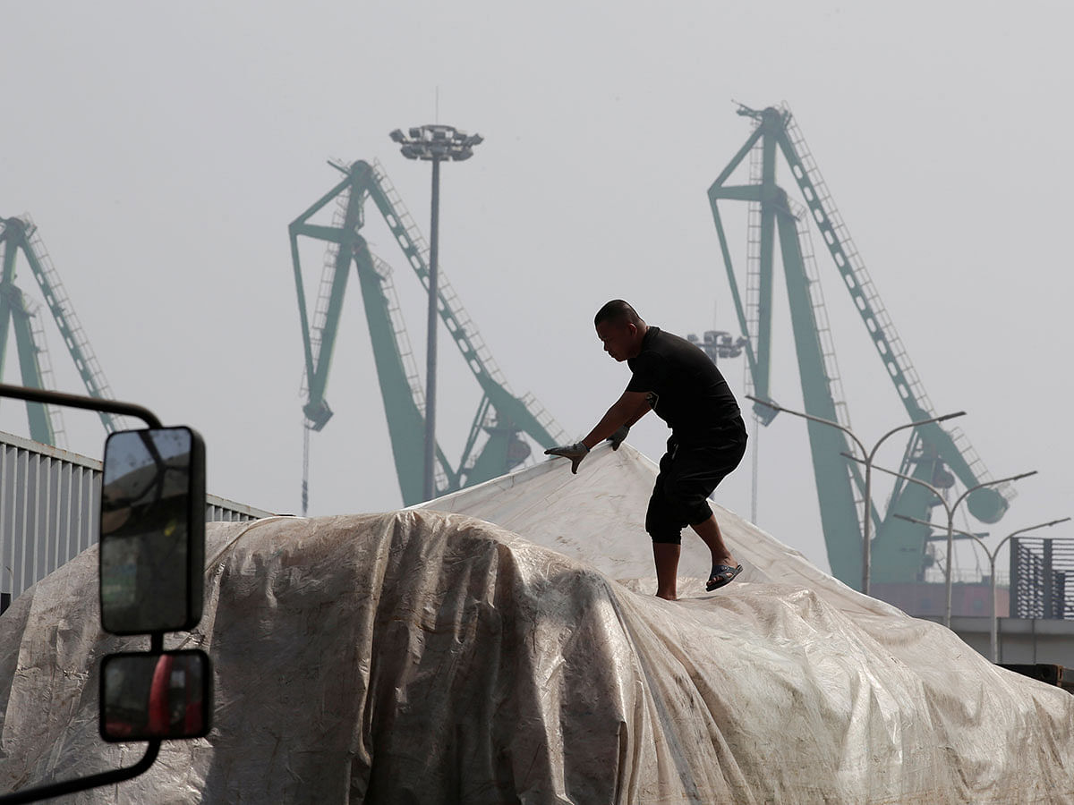A labourer works outside a logistics centre near Tianjin Port, in northern China on 16 May. Photo: Reuters