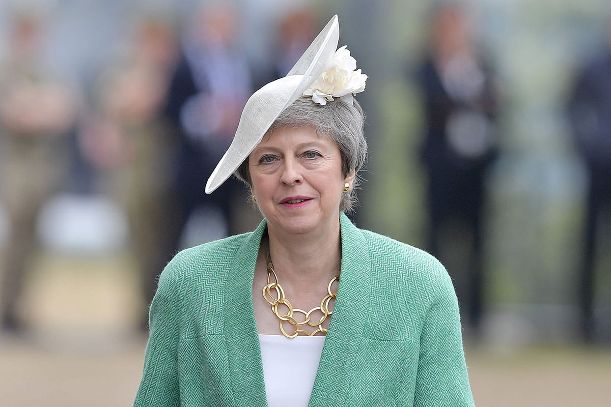 Britain`s Prime Minister Theresa May returns to her her seat after speaking during an event to commemorate the 75th anniversary of the D-Day landings, in Portsmouth, southern England, on 5 June 2019. Photo: AFP