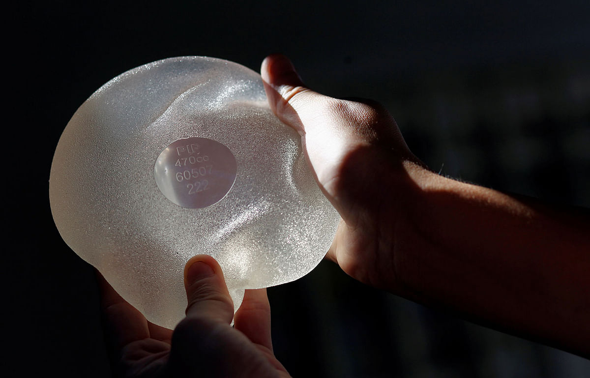 Rolon holds one of the silicone gel breast implants manufactured by PIP that she had to have removed, during an interview with Reuters in Buenos Aires. Photo: Reuters