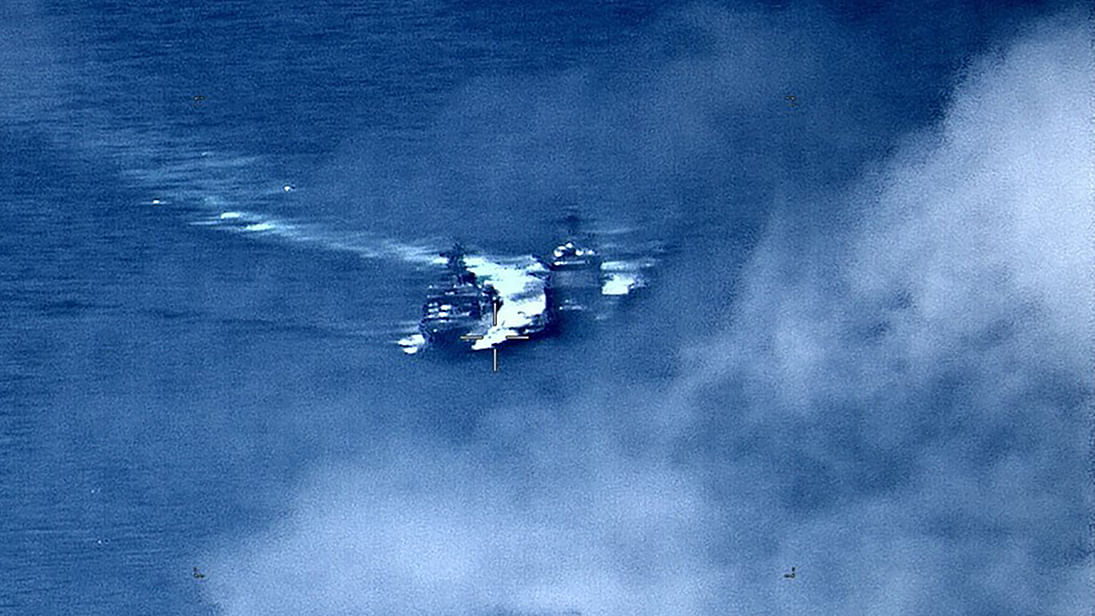 In this image released by the US Navy on 7 June, the Russian anti-submarine ship Admiral Vinogradov (L) sails close to the USS Chancellorsville. Russia and the US on 7 June accused each other of dangerous manoeuvres after their naval ships came close to collision in the East China Sea. Photo: AFP