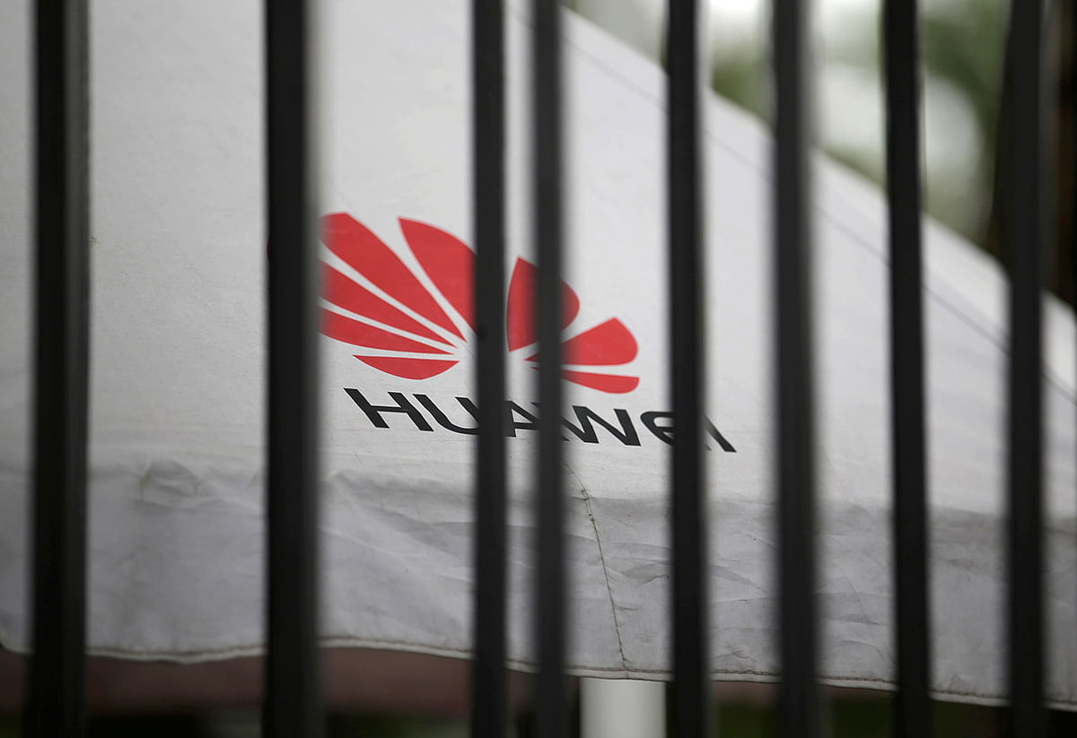 A Huawei logo is seen outside the fence at its headquarters in Shenzhen, Guangdong province, China on 29 May 2019. Reuters File Photo