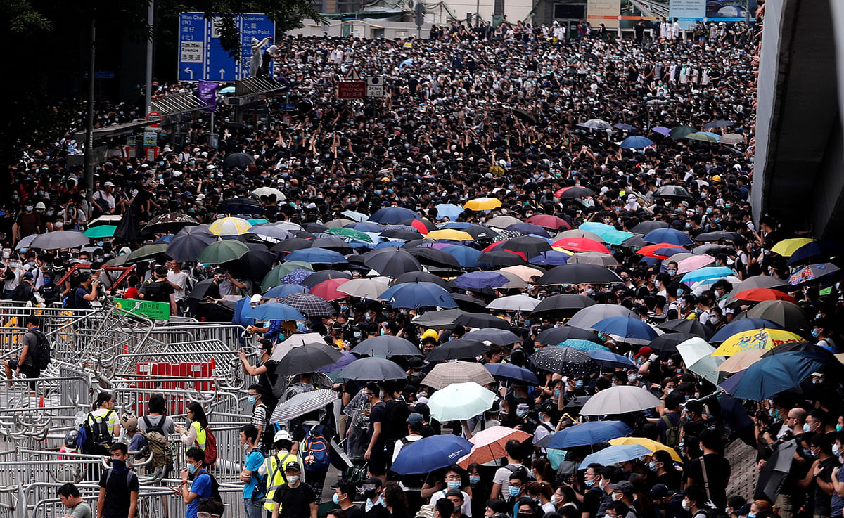 Protesters crowd along a main road during a demonstration against a proposed extradition bill in Hong Kong, China on 12 June. Photo: Reuters