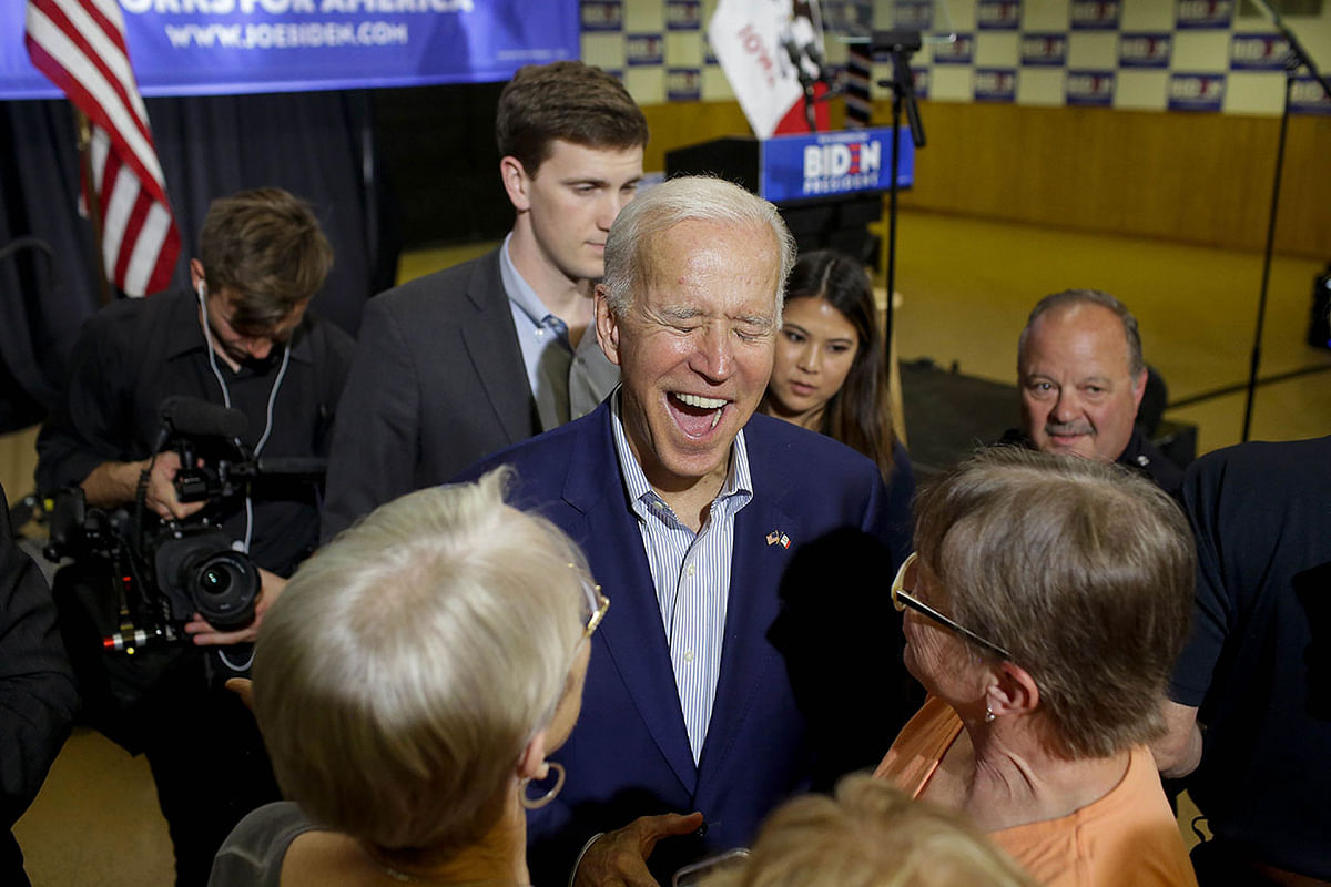 Former vice president and 2020 Democratic presidential candidate Joe Biden laughs as greets attendees during a campaign event on 11 June in Davenport, Iowa. Photo: AFP