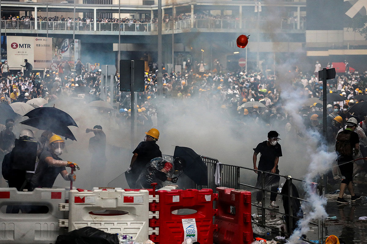Protesters react to a tear gas during a demonstration against a proposed extradition bill in Hong Kong, China on 12 June 2019. Photo: Reuters
