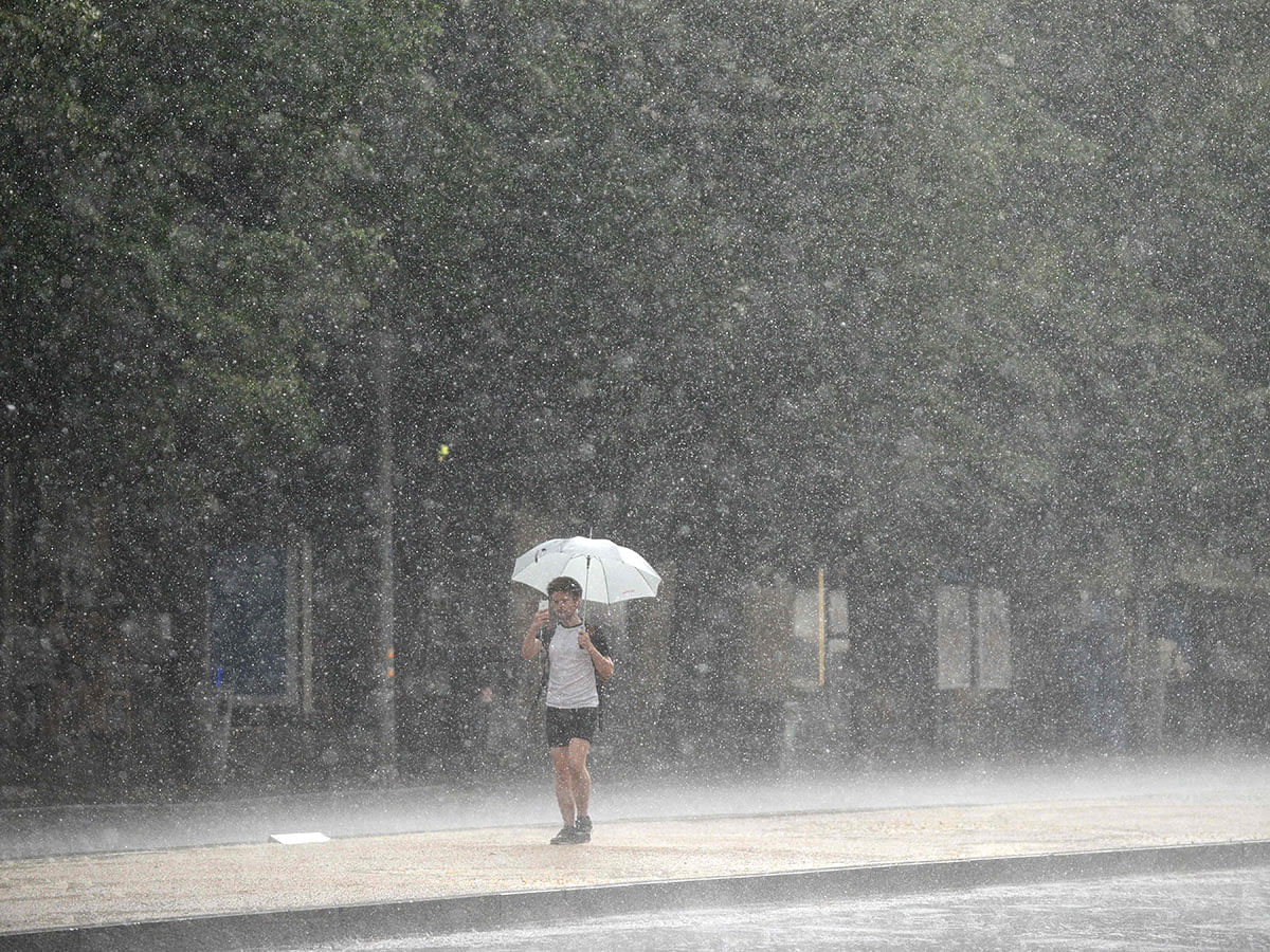 A man walks accross the Wenceslas Square as a heavy rain storm hits Prague on 12 June 2019. Photo: AFP