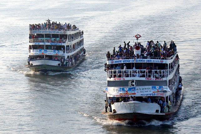 Two overcrowded launches make their way through the Buriganga river with homebound people leaving the capital Dhaka on Friday. Photo: Focus Bangla