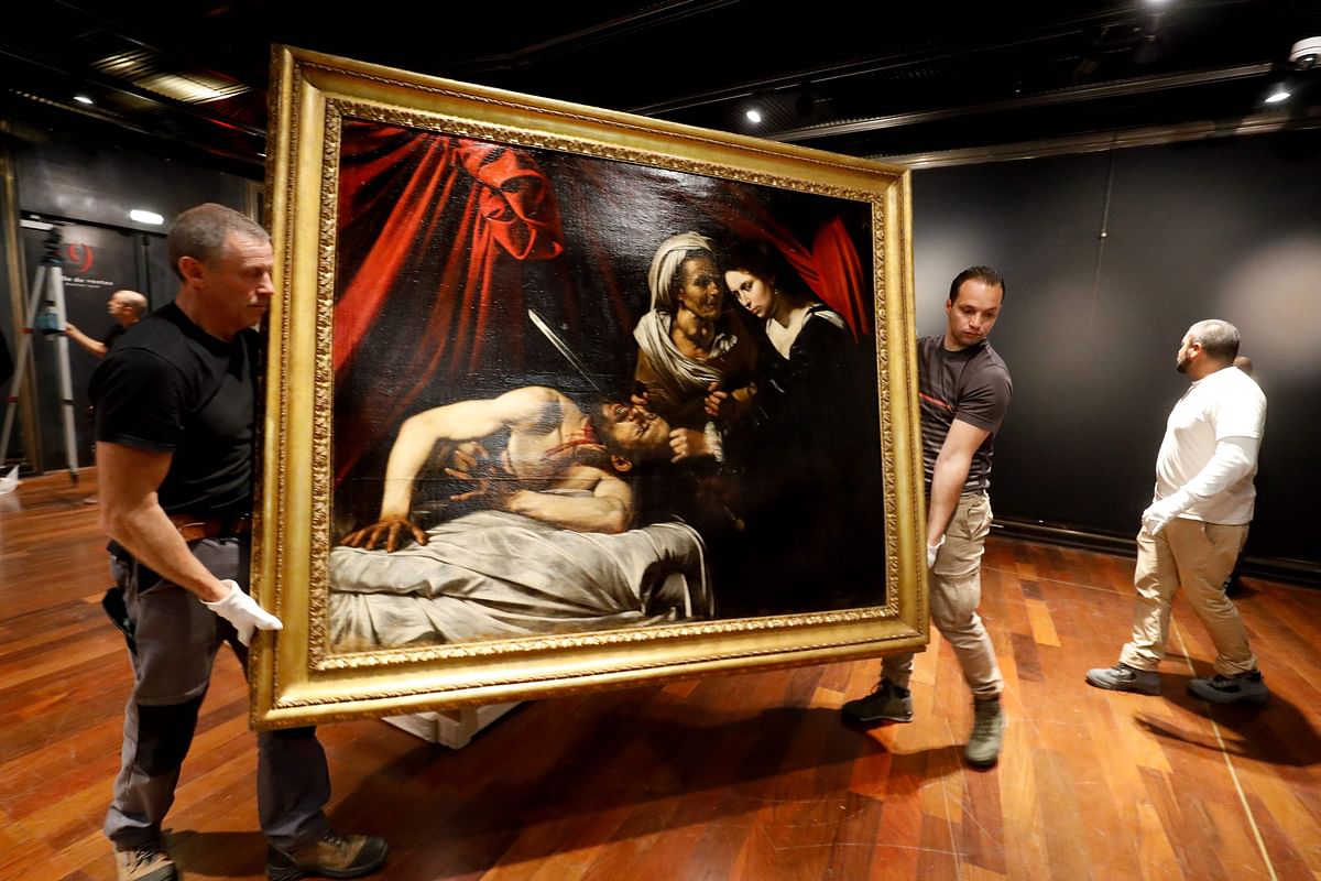 Workers carry a painting believed by some experts to be Caravaggio`s `Judith Beheading Holofernes` for its public presentation at the Drouot auction house in Paris on June 14, 2019 before it goes under the hammer on June 27 in Toulouse, the city where it was discovered five years ago. Photo: AFP 5.