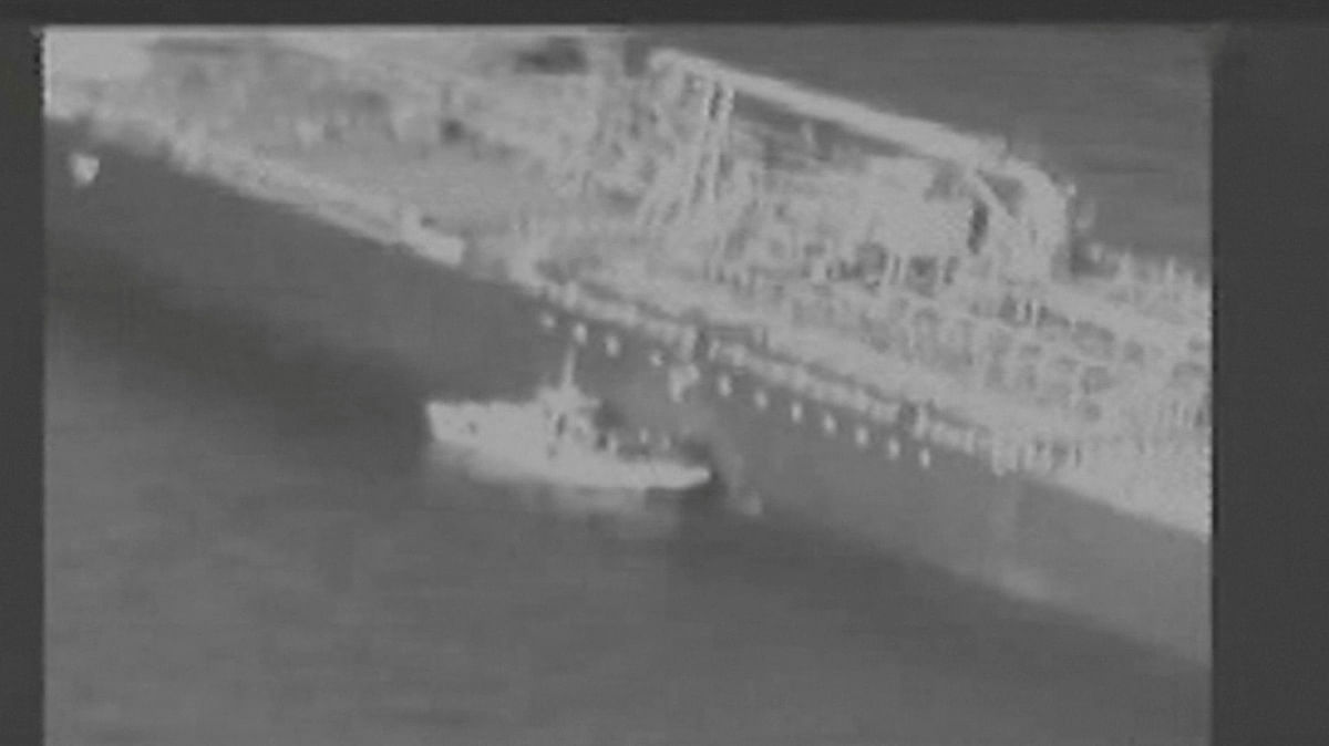 Still image taken from a US military handout video purports to show Iran`s Revolutionary Guard (IRGC) removing an unexploded limpet mine from the side of the Kokuka Courageous Tanker on 13 June. Photo: AFP