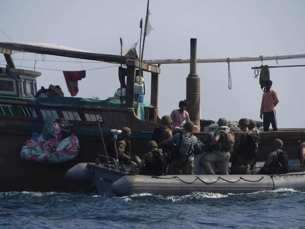 The United States Navy search and seizure team from The Arleigh Burke-class guided-missile destroyer USS McFaul`s (DDG 74) speak to fishermen aboard a Bahraini dhow during routine maritime security operations in Arabian Sea on 11 June. Photo: Reuters