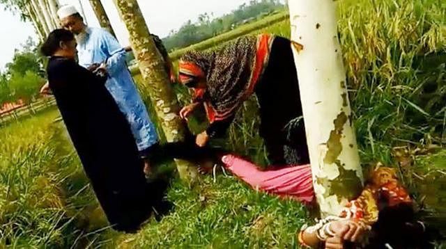 A three-month pregnant housewife, tied to trees, kicked and punched over a land dispute at Kaida village in Nakla upazila on 10 May. Photo: Collected
