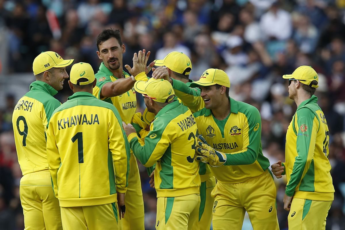 Australia`s Mitchell Starc celebrates with teammates after taking the wicket of Sri Lanka`s Thisara Perera for seven during the 2019 Cricket World Cup group stage match between Sri Lanka and Australia at The Oval in London on 15 June, 2019. Photo: AFP