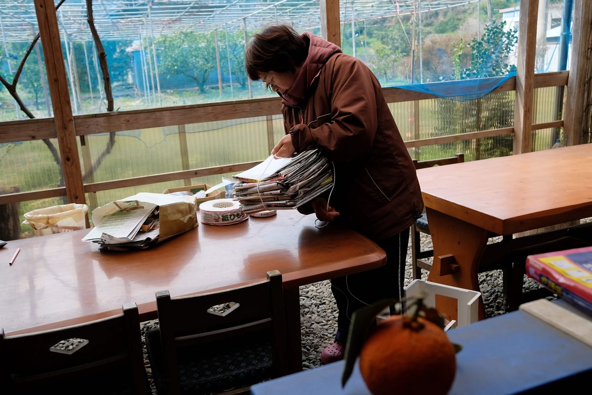 This picture taken on 14 March 2019 shows Japanese resident Saeko Takahashi bundling newspapers at her home in the town of Kamikatsu, Tokushima prefecture. Photo: AFP
