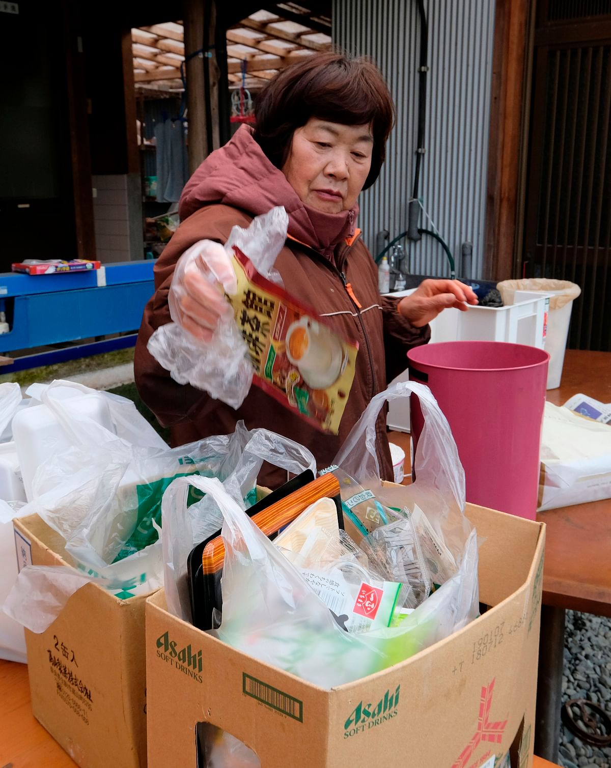 This picture taken on 14 March 2019 shows Japanese resident Saeko Takahashi separating trash into different boxes at her home kitchen in the town of Kamikatsu, Tokushima prefecture. Photo: AFP