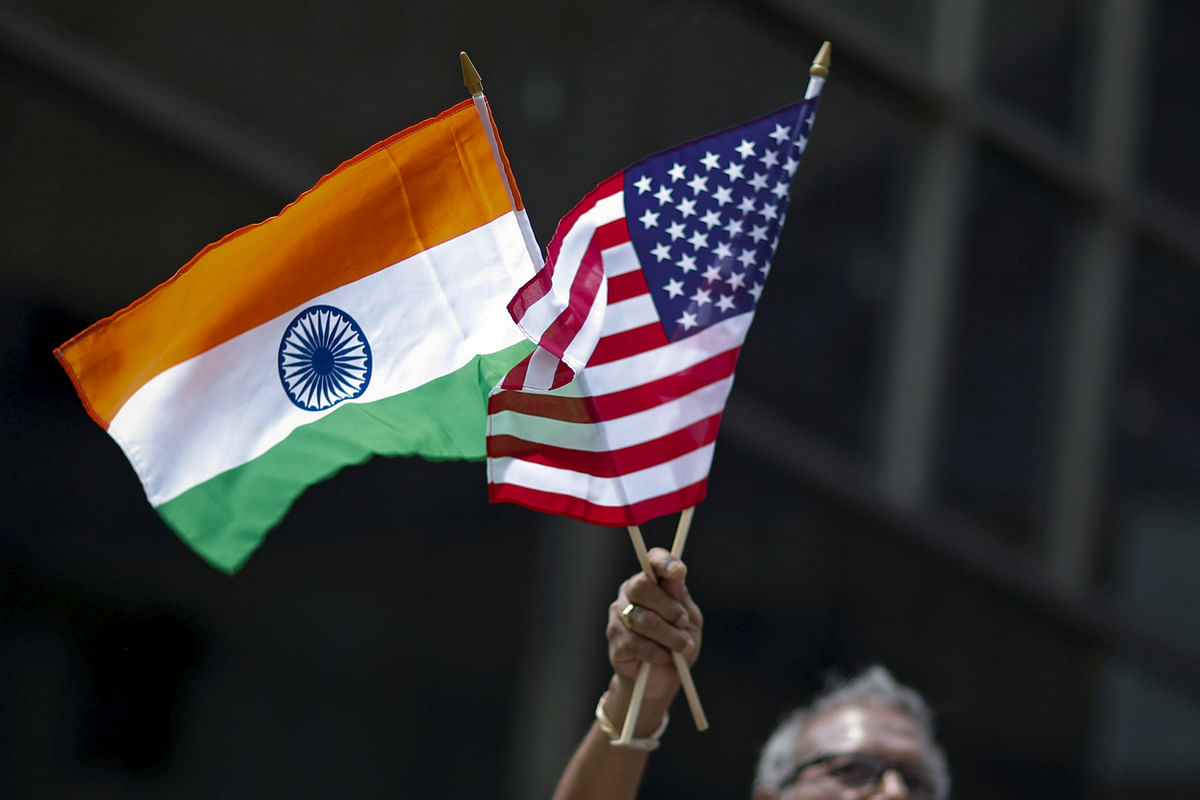 A man holds the flags of India and the US while people take part in the 35th India Day Parade in New York August 16, 2015. Photo: Reuters Tag: India, USA