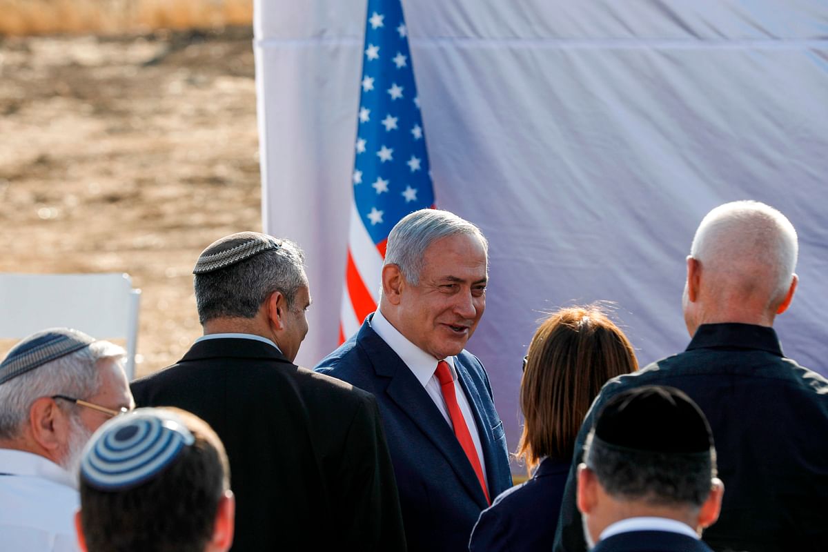 Israeli prime minister Benjamin Netanyahu (C) attends the unveiling ceremony for the new settlement of `Ramat Trump`, or `Trump Heights` in English, named after the incumbent US president, in the Israeli-annexed Golan Heights on 16 June Netanyahu unveiled a `Trump Heights` sign to mark the site of the new settlement, which comes after the US president in late March recognised Israeli sovereignty over the part of the strategic plateau it seized from Syria in the 1967 Six-Day war. Photo: AFP
