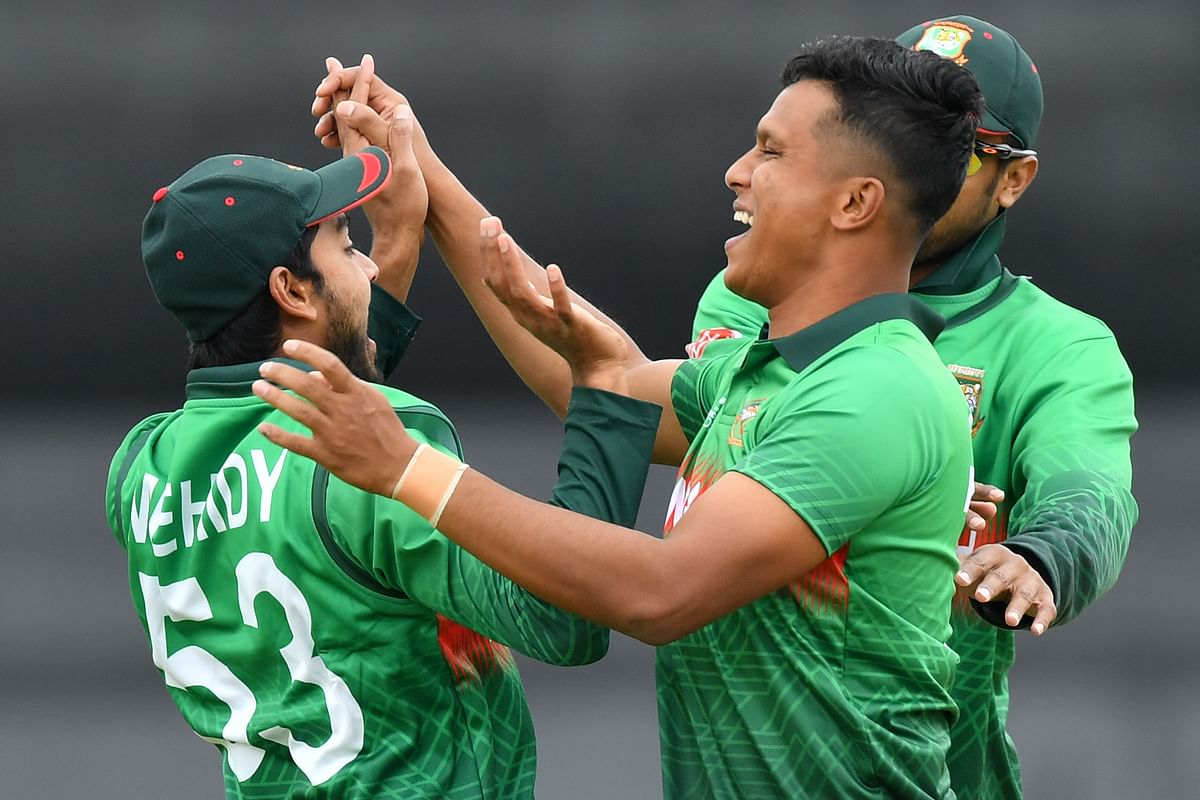 Mohammad Saifuddin (R) celebrates taking the wicket of West Indies` Chris Gayle for 0 runs during the 2019 Cricket World Cup group stage match between West Indies and Bangladesh at The County Ground in Taunton, southwest England, on June 17, 2019.