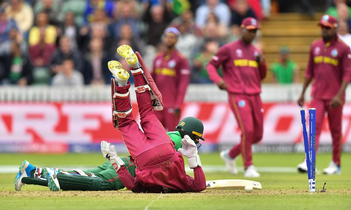 Bangladesh`s Liton Das (floor back) and West Indies` Shai Hope (floor front) collide in an unsuccessfull attempted run out during the 2019 Cricket World Cup group stage match between West Indies and Bangladesh at The County Ground in Taunton, southwest England, on 17 June 2019.