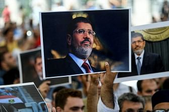 People hold picture of Egyptian president Mohamed Morsi during a symbolic funeral cerenomy on 18 June 2019 at Fatih mosque in Istanbul. Thousands joined in prayer in Istanbul on Tuesday for former Egyptian president Mohamed Morsi who died the previous day after collapsing during a trial hearing in a Cairo court. Photo: AFP