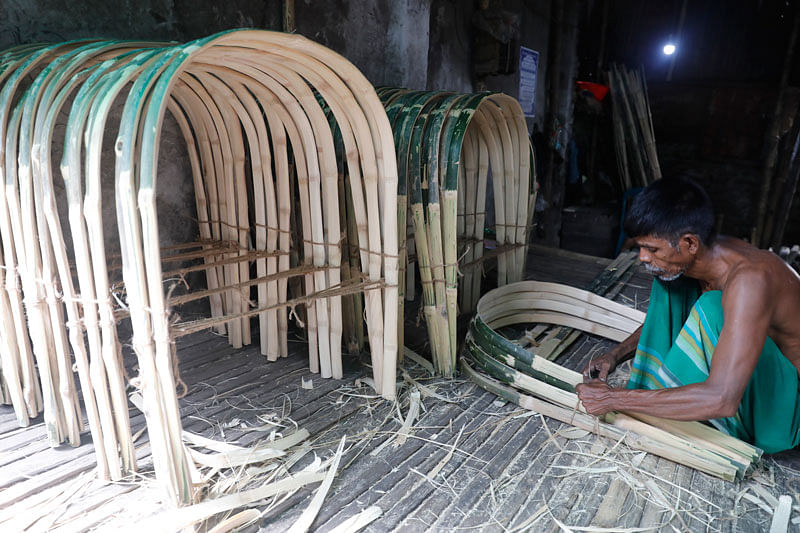 A worker busy making a wooden frame of rickshaw in Tawapotti, South Keranigank, Dhaka on 17 June 2019. Photo: Dipu Malakar