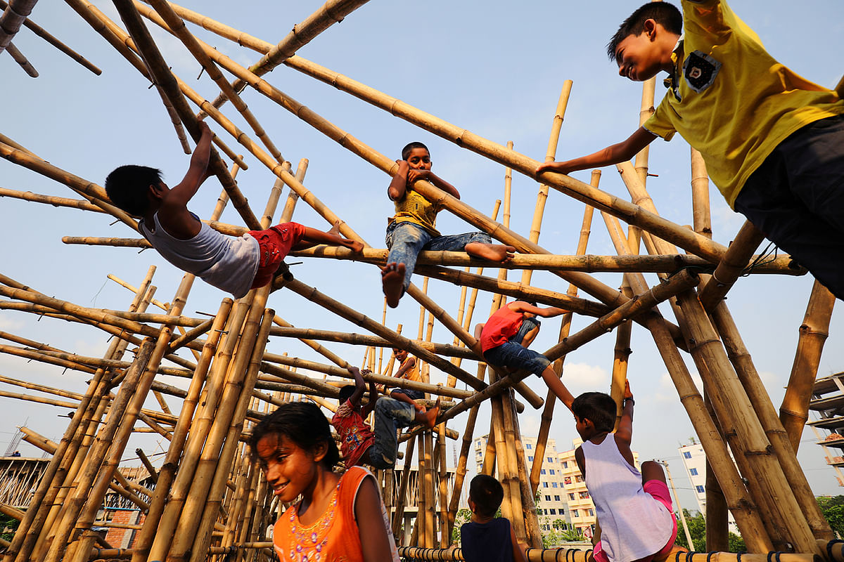 Children play at a child friendly bamboo-made place in Dhaka, Bangladesh on 16 June 2019. Photo: Reuters
