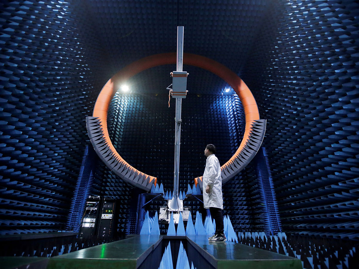 An engineer stands under a base station antenna of 5G in Huawei`s SG178 multi-probe spherical near-field testing system at its Songshan Lake Manufacturing Center in Dongguan. Photo: AFP