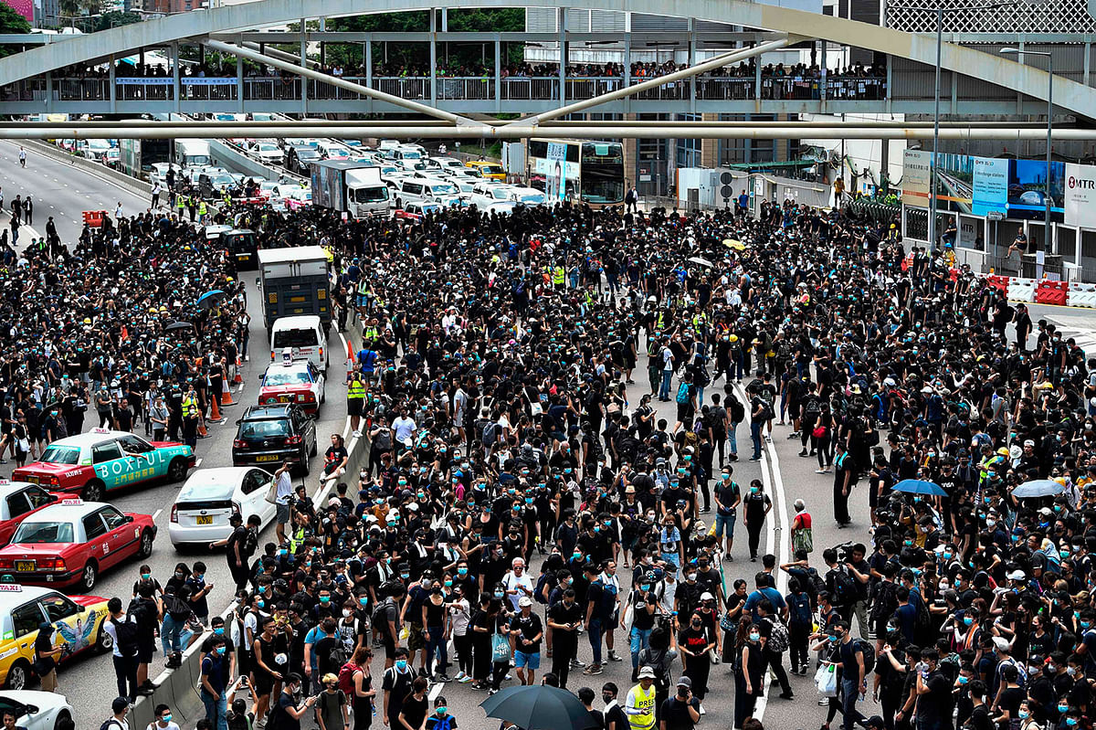 Protesters occupy a main road outside the government headquarters in Hong Kong on 21 June 2019. Photo: AFP