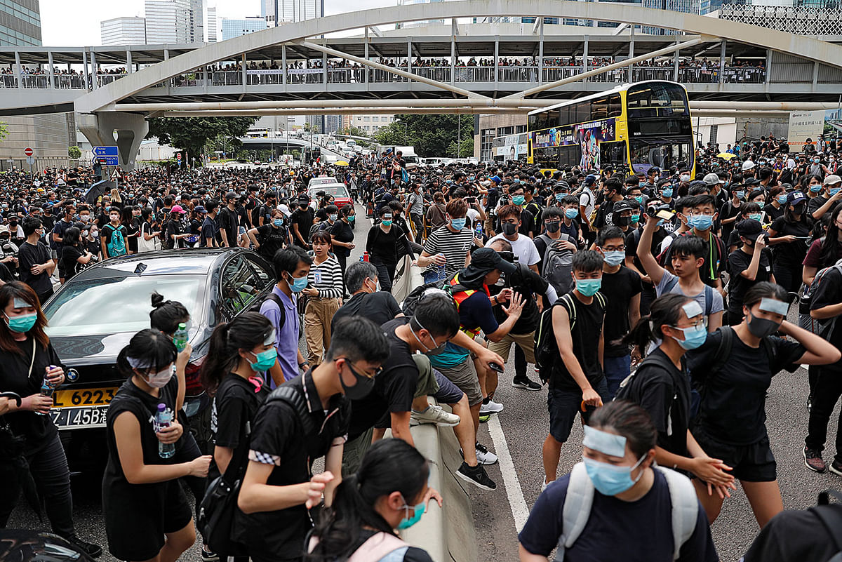 Protesters block a road during a demonstration demanding Hong Kong’s leaders to step down and withdraw the extradition bill, in Hong Kong, China on 21 June 2019. Photo: Reuters