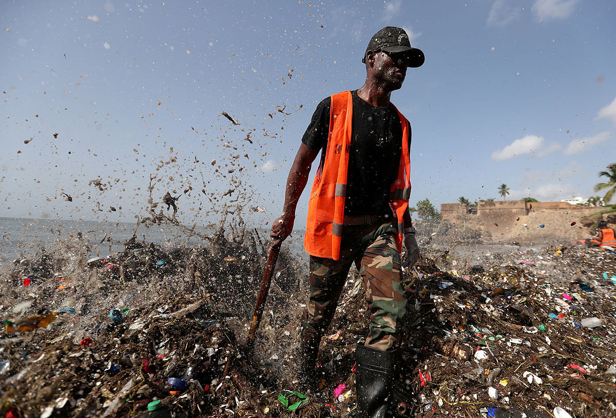 A soldier walks on the shores of Montesinos beach, which is covered in plastic and other debris, during a cleanup in Santo Domingo, Dominican Republic on 19 July 2018. Photo: AFP