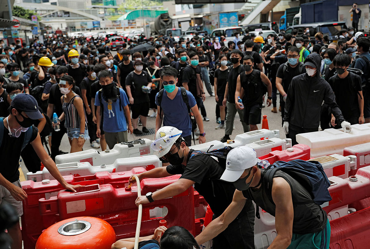 Protesters use barricades to block a road during a demonstration demanding Hong Kong’s leaders to step down and withdraw the extradition bill, in Hong Kong, China on 21 June 2019. Photo: Reuters