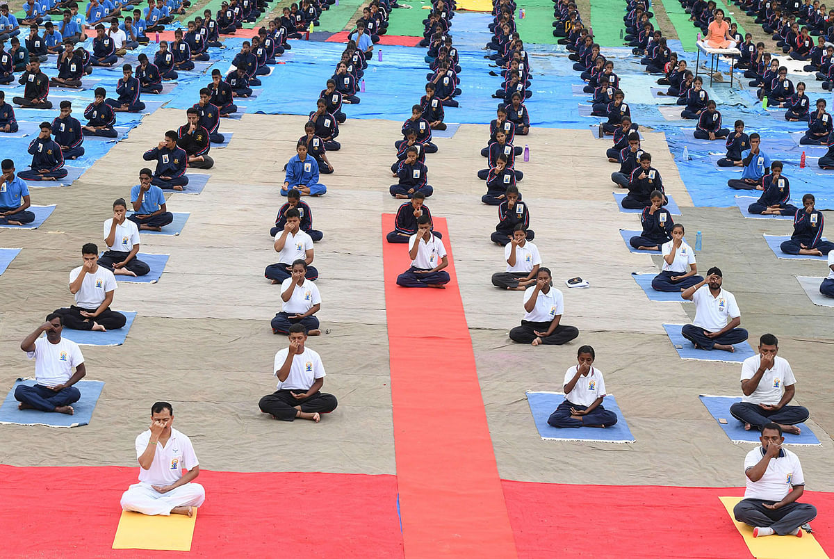 Members of India`s National Cadet Corps (NCC) take part in a mass yoga session to mark International Yoga Day at the Bison Polo Grounds in Hyderabad on 21 June 2019. Photo: AFP