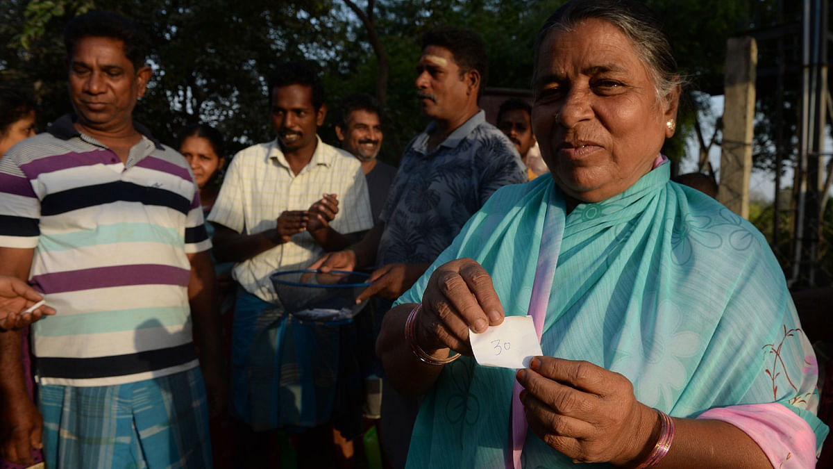 In this photo taken on 20 June 2019, an Indian resident holds a numbered piece of paper picked as lots for people waiting for an opportunity to get water from a community well in Chennai after reservoirs for the city ran dry. Photo: AFP