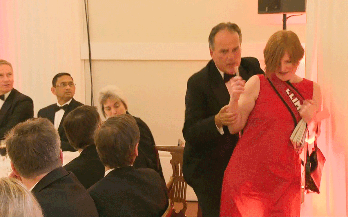 A still image taken from UK Pool video footage on 21 June 2019 shows Conservative MP Mark Field tackling a Greenpeace climate protester at a dinner at Mansion House in the City of London on 21 June 2019. Photo: AFP
