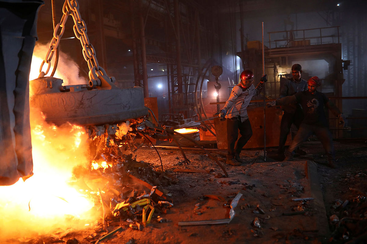 Workers melt metal scraps in the furnace of a steel mill to produce rods in Dhaka, Bangladesh on 22 June 2019. Photo: Reuters