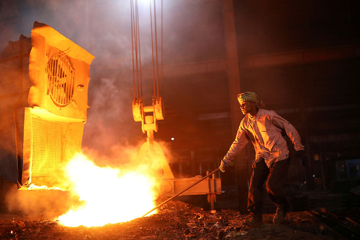 Workers melt metal scraps in the furnace of a steel mill to produce rods in Dhaka, Bangladesh on 22 June 2019. Photo: Reuters