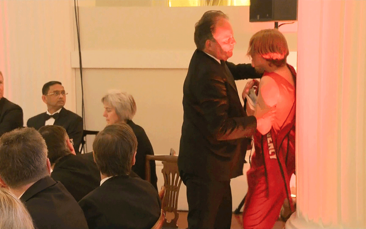 A still image taken from UK Pool video footage on 21 June 2019 shows Conservative MP Mark Field tackling a Greenpeace climate protester at a dinner at Mansion House in the City of London on 21 June 2019. Photo: AFP