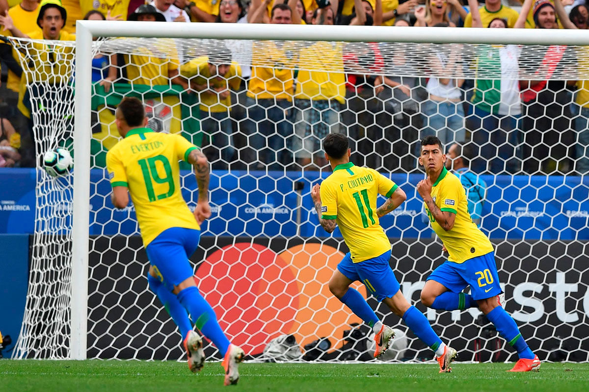 Brazil`s Roberto Firmino (R) celebrates after scoring the team`s second goal against Peru during their Copa America football tournament group match at the Corinthians Arena in Sao Paulo, Brazil, on 22 June 2019. Photo: AFP