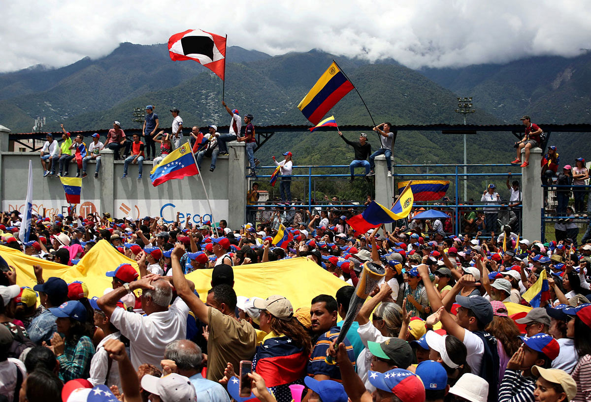 Supporters of Venezuelan opposition leader Juan Guaido (not pictured), who many nations have recognised as the country`s rightful interim ruler, listen as he addresses the crowd in Merida, Venezuela on 15 June 2019. Reuters File Photo