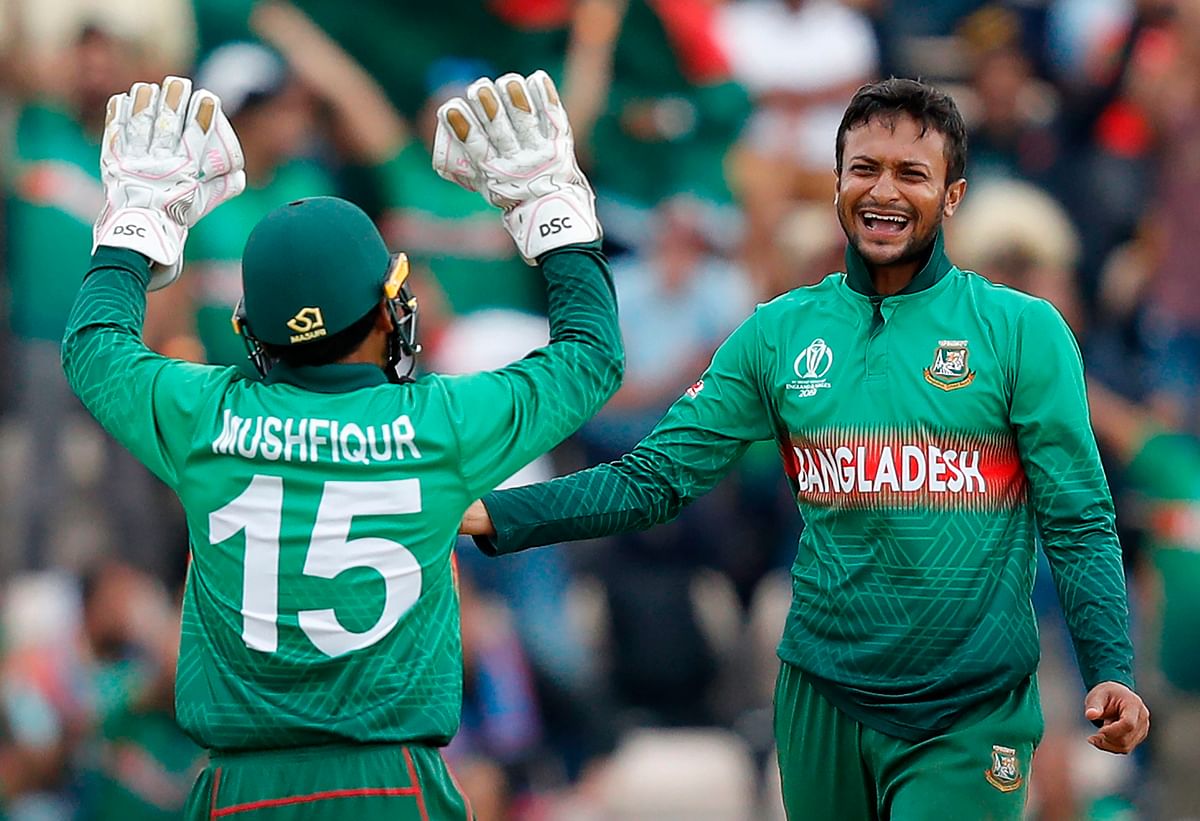 Bangladesh`s Shakib Al Hasan (R) celebrates with teammate Mushfiqur Rahim after the dismissal of Afghanistan`s Najibullah Zadran during their 2019 Cricket World Cup group stage match at the Rose Bowl in Southampton, southern England, on June 24, 2019. AFP