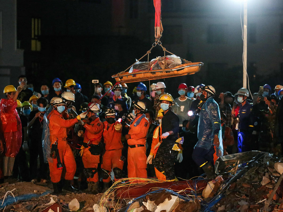Rescue workers recover the body of a victim from the debris of an under-construction building two days after it collapsed in Sihanoukville early on 24 June, 2019. Photo: AFP