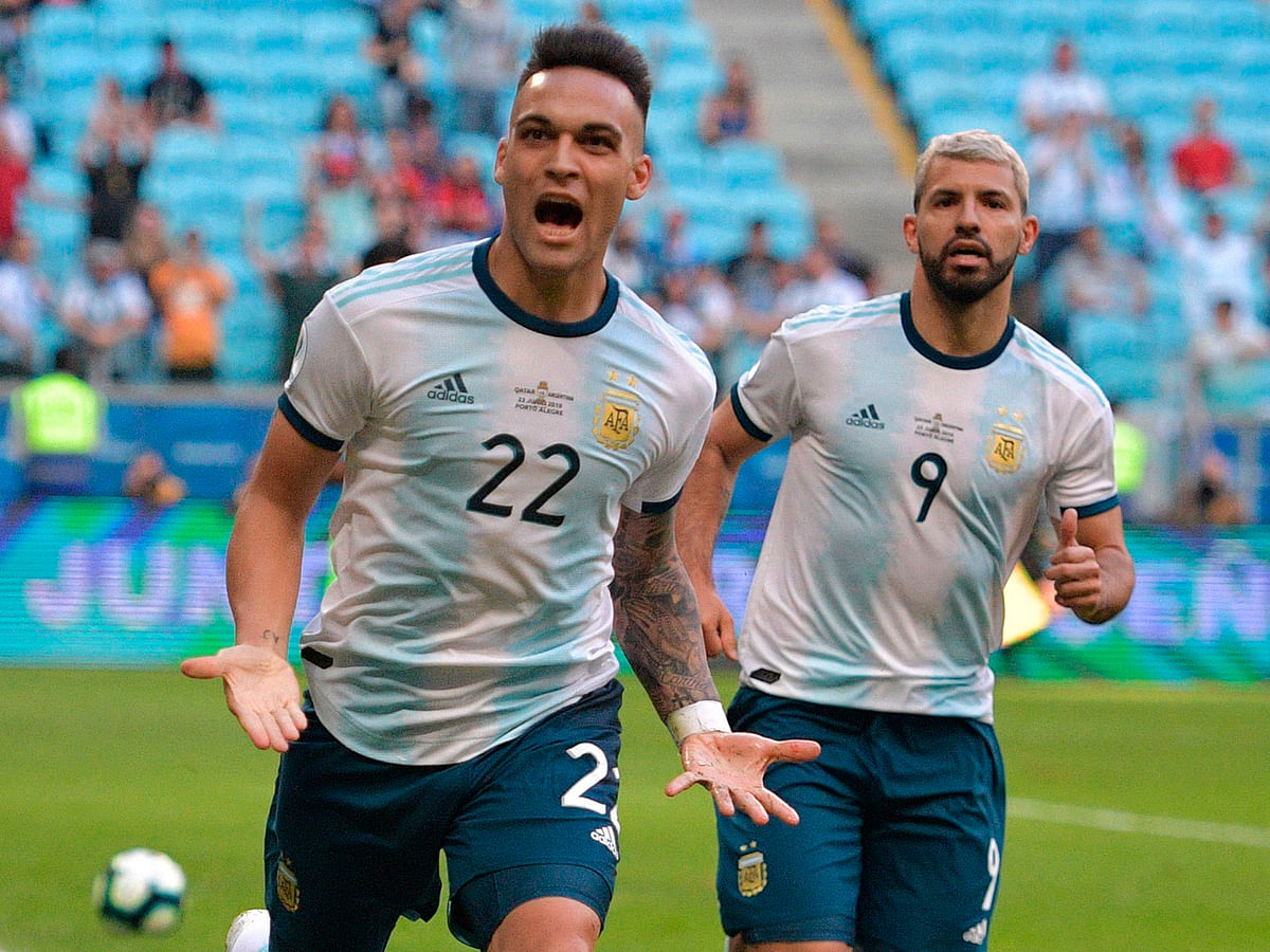 Argentina`s Lautaro Martinez (L) is followed by teammate Sergio Aguero after scoring against Qatar during their Copa America football tournament group match at the Gremio Arena in Porto Alegre, Brazil, on 23 June, 2019. Photo: AFP