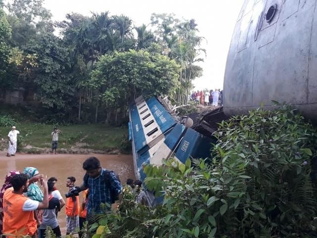 One of the bogies of Upaban Express lies on a canal after being overturned in Moulvibazar`s Kulaura early Monday . Photo: Kalyan Prasun